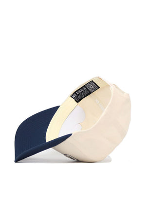 The No Rivals Utah State Triangle Game Cap Hat is shown upside down, highlighting its inside lining, labels, and stitching. This cap features a structured fit, dark blue brim, light crown, and beige-navy design for lasting shape.