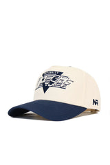 The No Rivals Utah State Triangle Game Cap Hat is a cream structured baseball cap with a navy bill, "University Free Style" and star embroidery in navy/white, NR initials on the side, and an adjustable snapback closure.