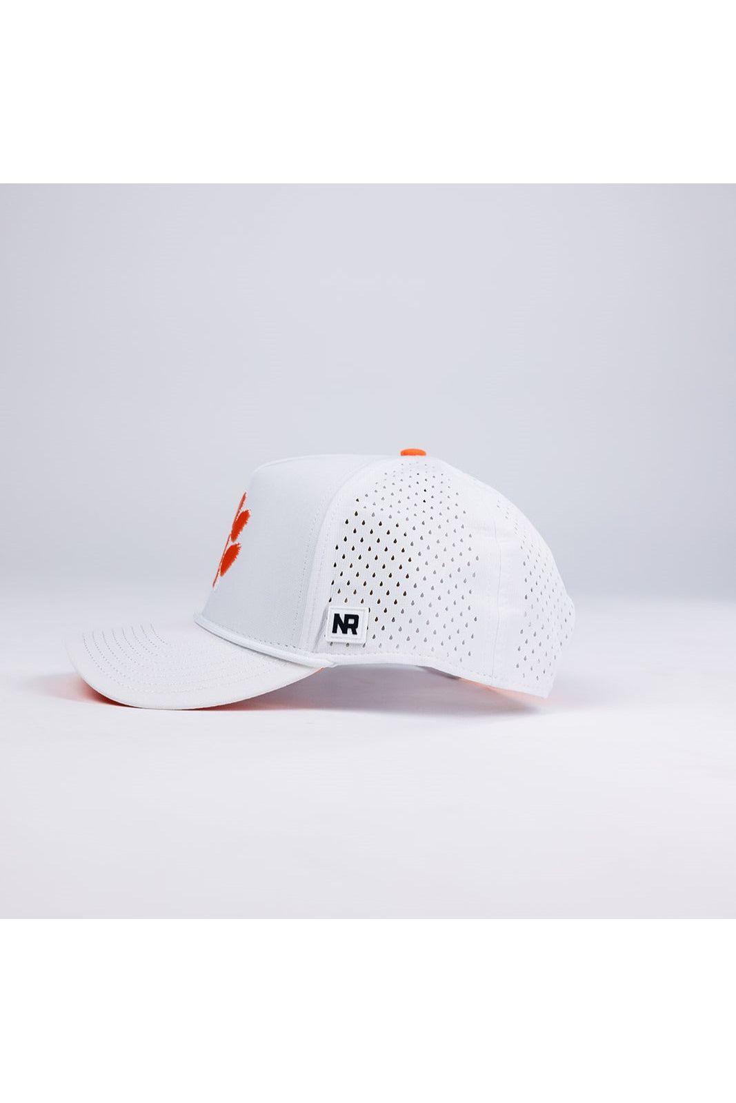 The Clemson Gameday Hat by No Rivals is a white polyester-cotton snapback with small ventilation holes, an orange logo on the front, and a rectangular NR label on the brim. Shown on a plain white background—perfect for your gameday look.