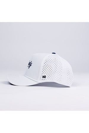 The No Rivals Liberty Gameday Hat is a white mesh snapback baseball cap with a curved brim, side ventilation holes, and an NR logo tag on the side. Shown on a plain white background from the side view.
