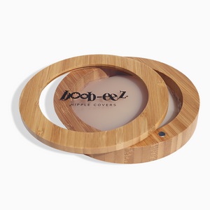 Product shot of the Boob-eez Bamboo Compact with Light tint Headlight Hiders inside, close-up side shot showing the beautiful wood grain, magnetic closure, and translucent window to display the Headlight Hiders inside