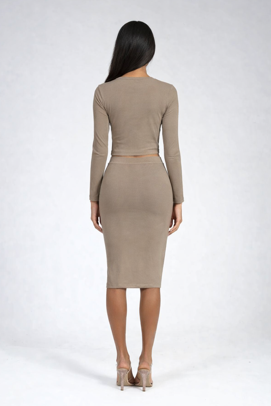 Woman wearing an olive long-sleeve top and skirt set on a white background