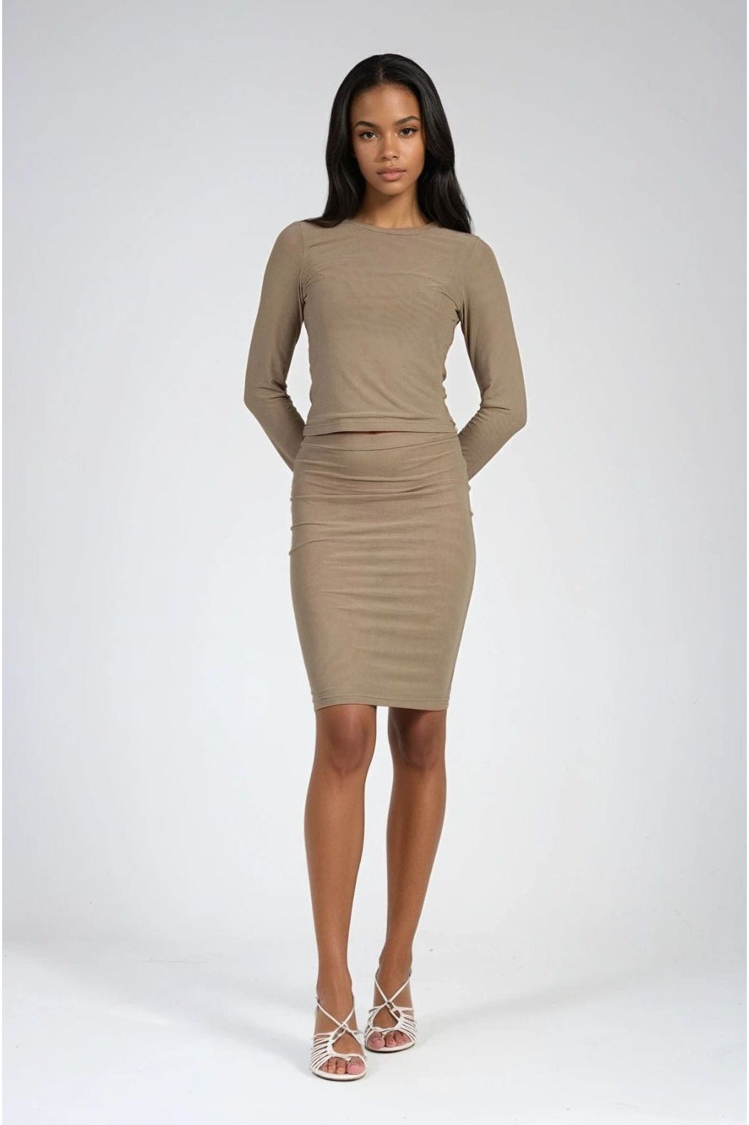Woman wearing an olive green long-sleeve dress on a white background