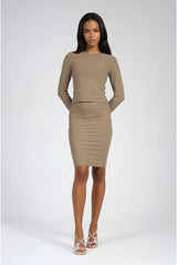Woman wearing an olive green long-sleeve dress on a white background