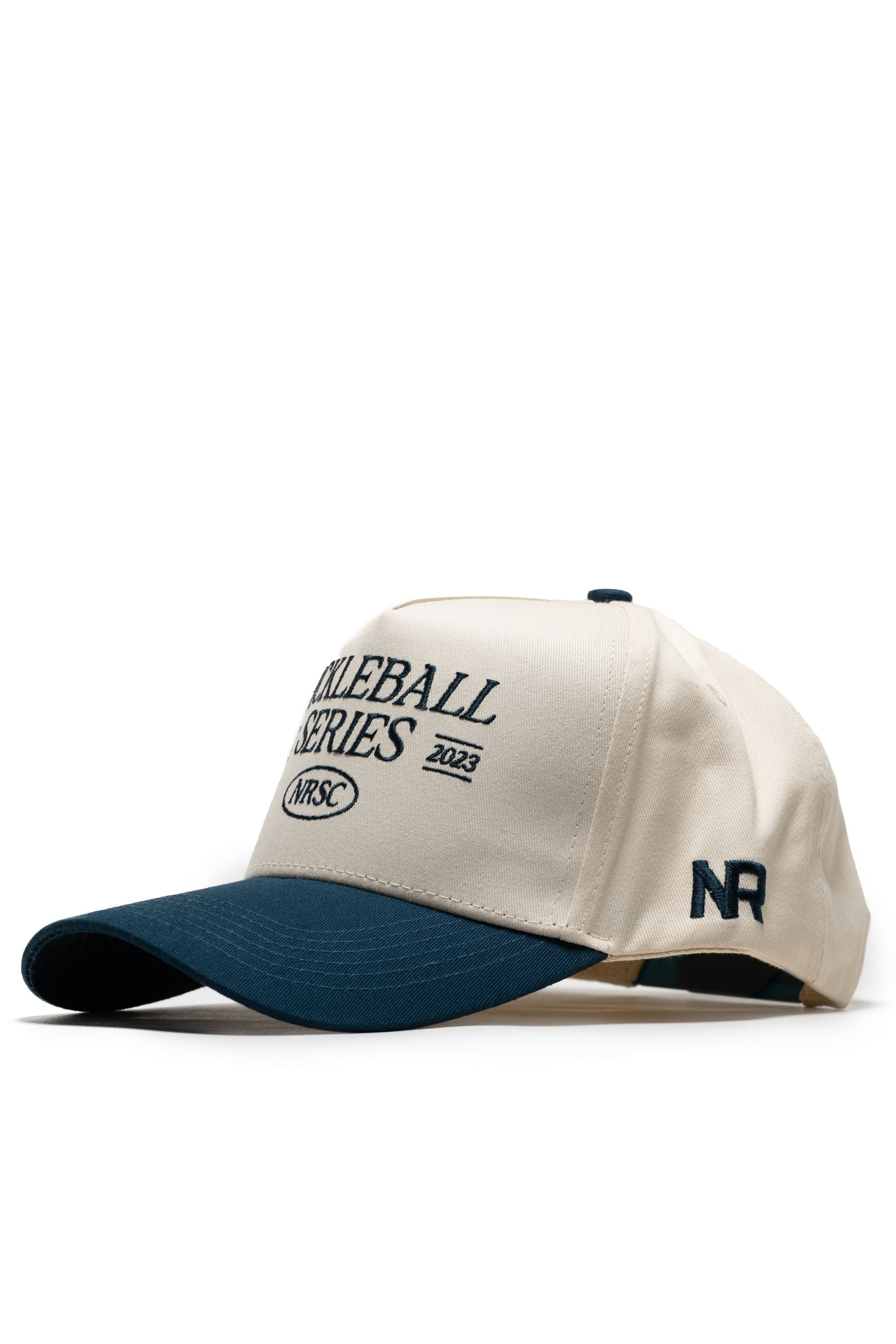 The Old School Pickleball Hat - Classic Blue by No Rivals features a cream crown, navy blue brim, and high-quality cotton. "SOLEBALL SERIES 2023 NRSC" is on the front, with NR initials embroidered in navy for a structured fit.