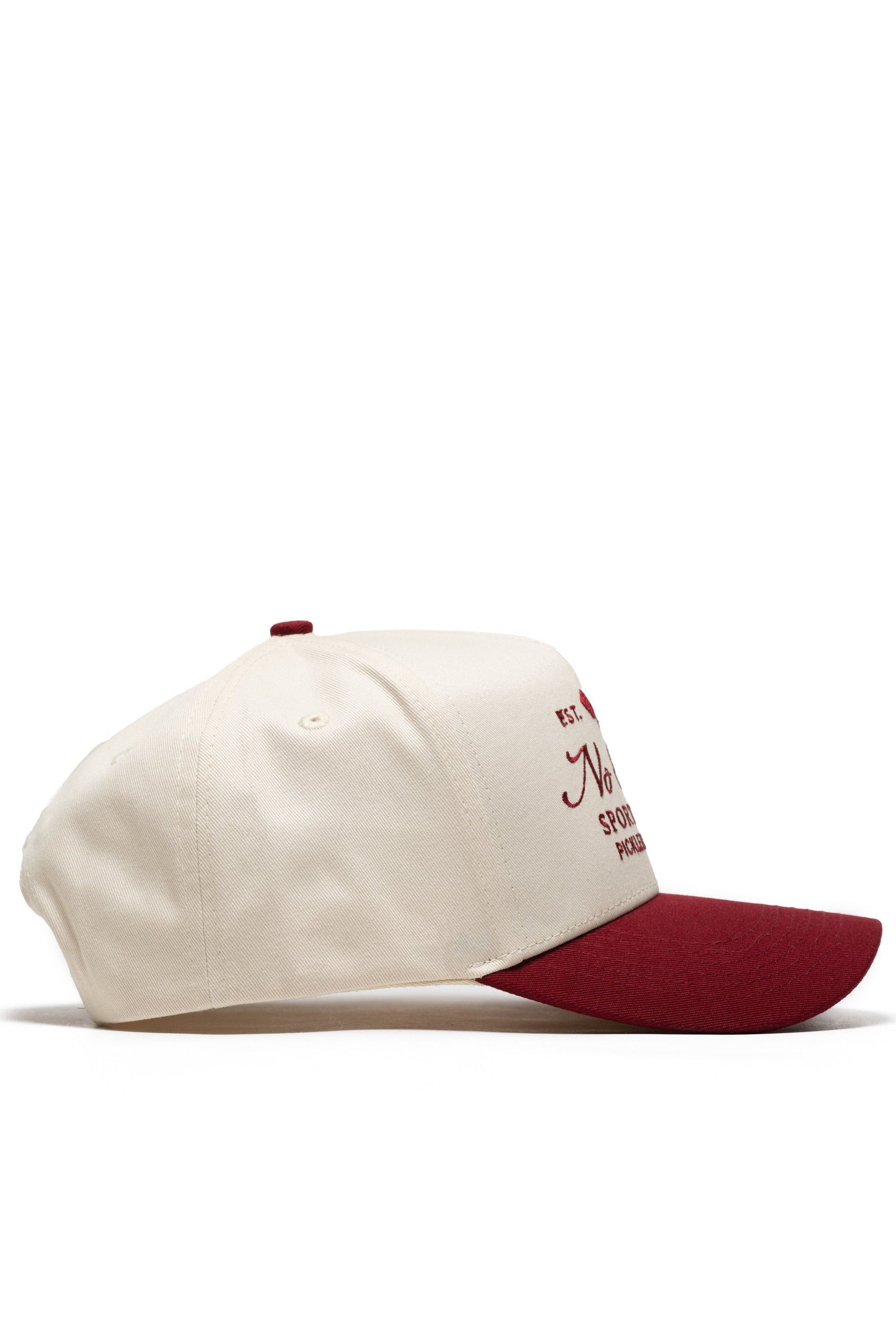 The No Rivals Sports Club Pickleball Hat - Classic Red is shown in side view, featuring a cream snapback design with a maroon brim, structured fit, high quality cotton, and partially visible maroon front text and design.