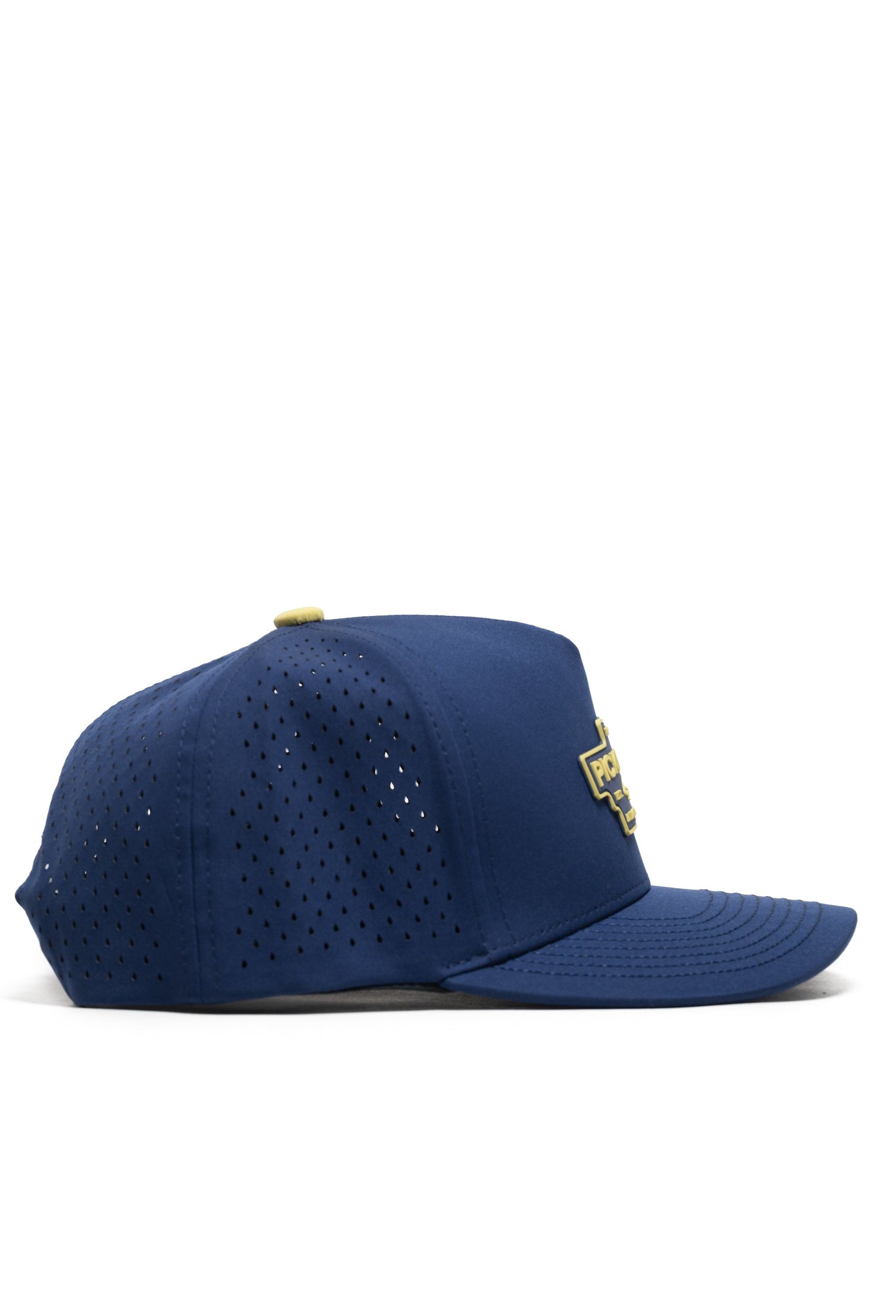 The No Rivals Athletic Pickleball Series Hat in navy is a structured snapback with side ventilation holes and a yellow and white embroidered front patch, shown from the side against a white background.