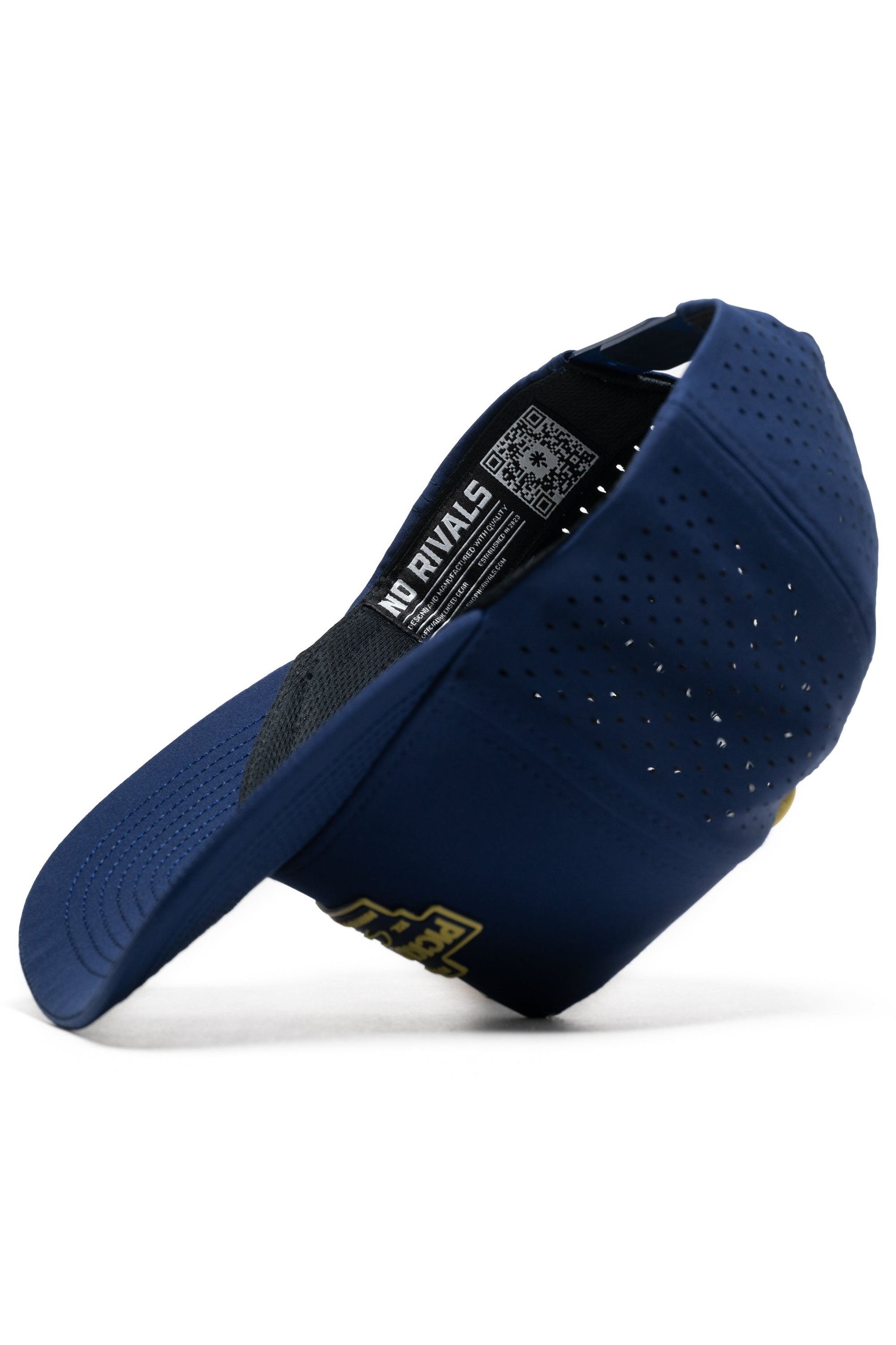 The Athletic Pickleball Series Hat - Navy by No Rivals is a structured athletic snapback with mesh back panels, shown from the side, and features an inner tag labeled NO RIVALS plus a QR code.