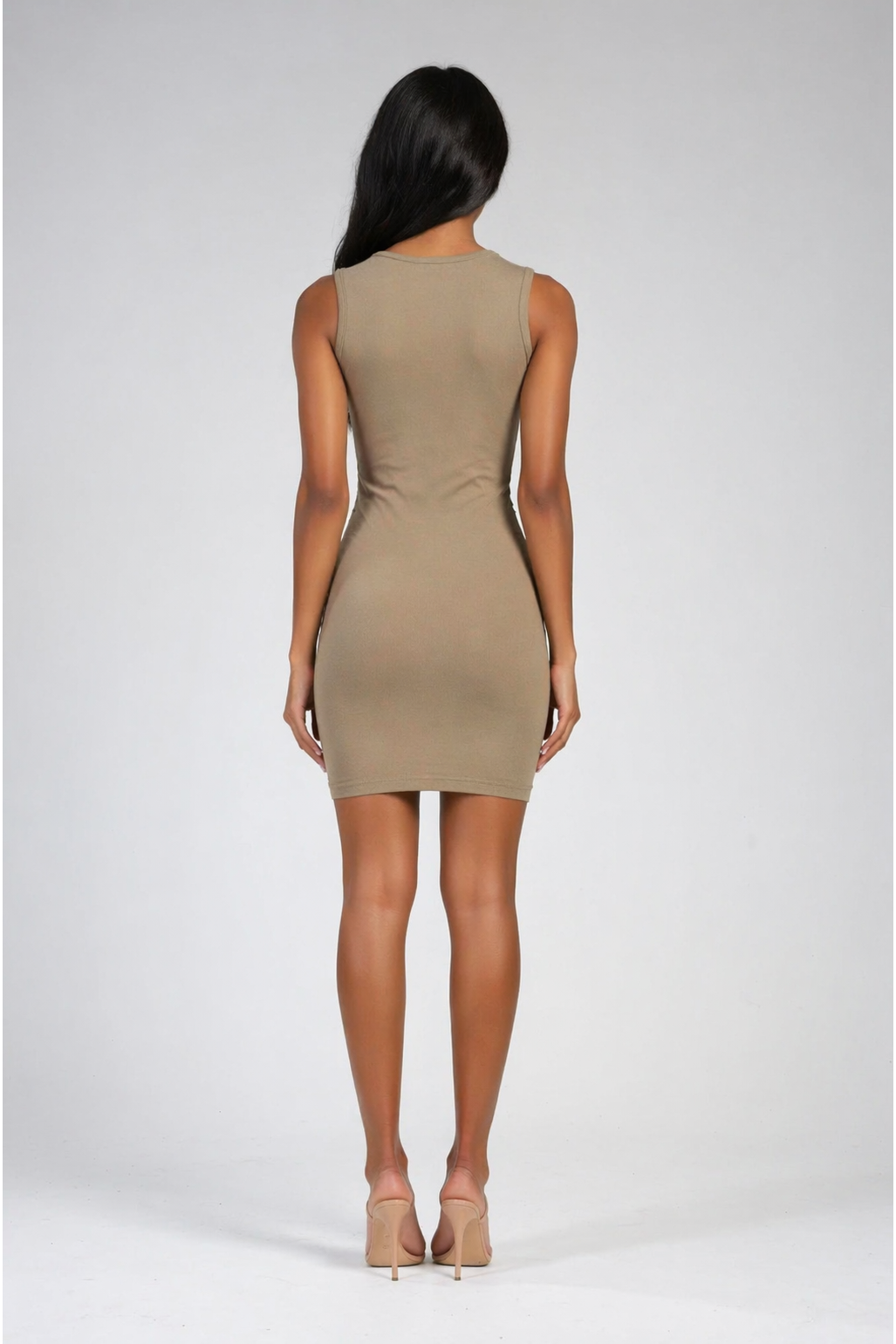 Woman wearing an olive dress on a white background