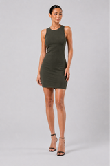 Woman wearing a green dress on a gray background