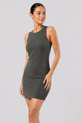 Woman wearing a gray dress against a plain background