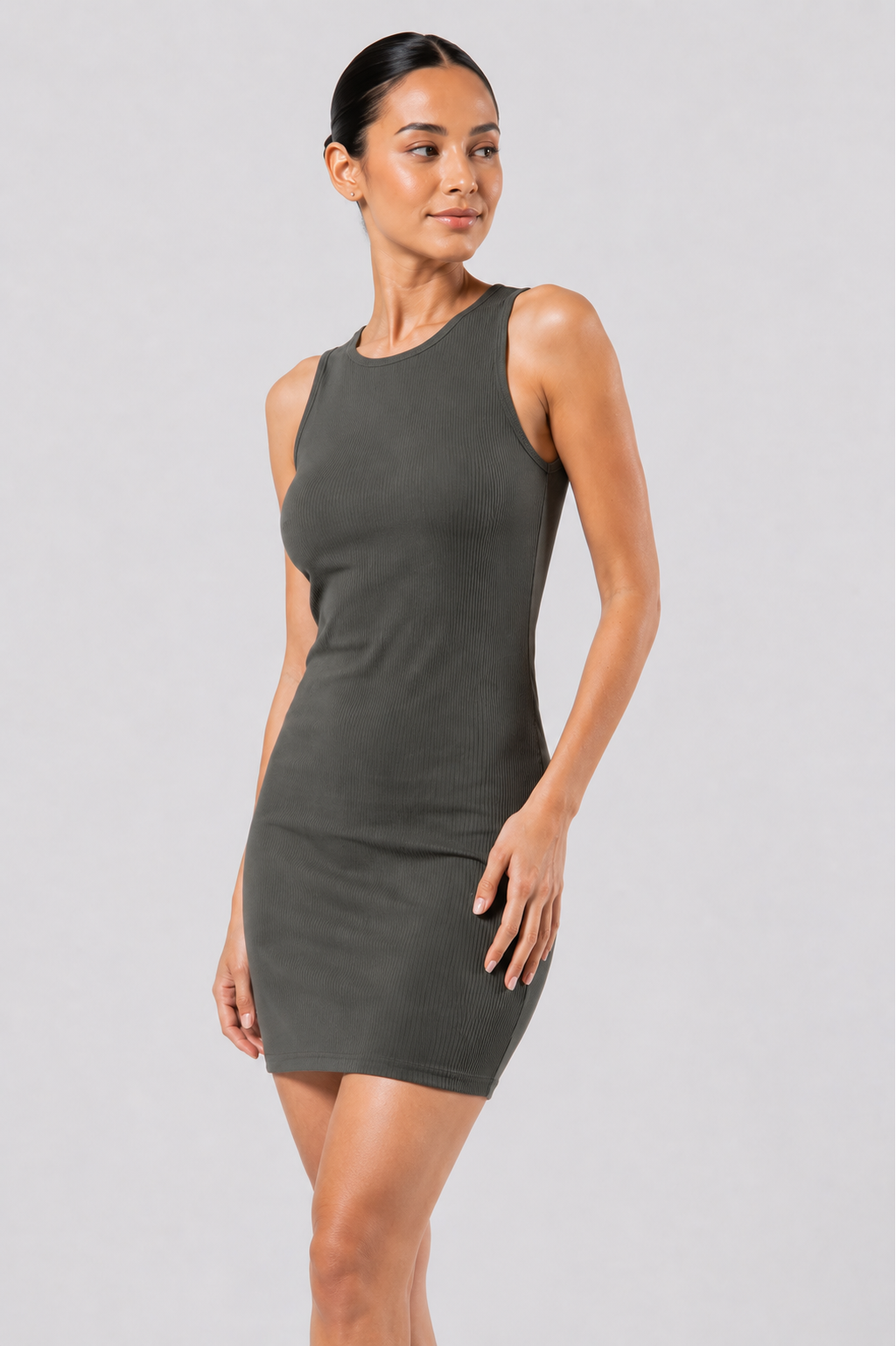 Woman wearing a gray dress against a plain background