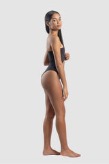 Woman wearing a black swimsuit on a white background