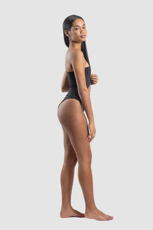 Woman wearing a black swimsuit on a white background