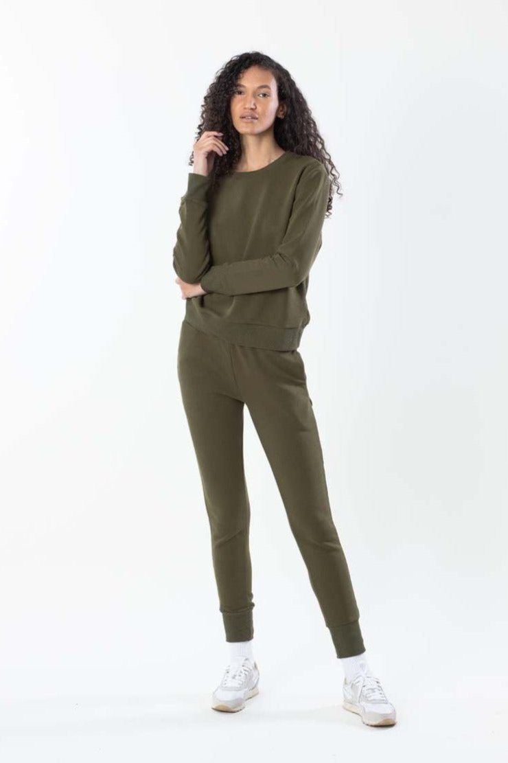 Model in olive sweatshirt with matching olive sweatpants, front view