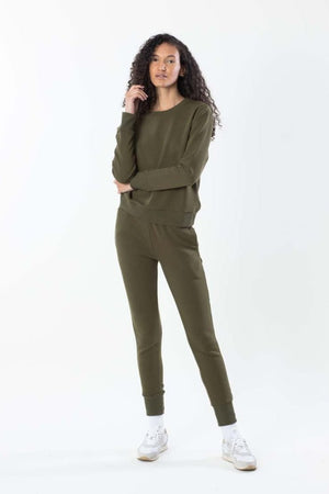 Model in olive sweatshirt with matching olive sweatpants, front view