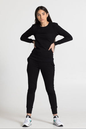 Person wearing a black outfit on a white background