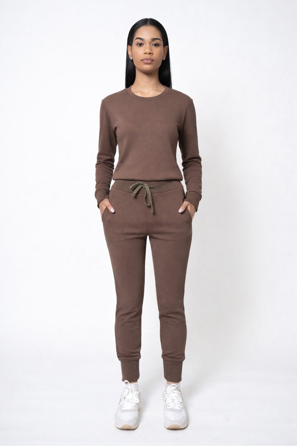 Woman wearing a brown tracksuit on a white background