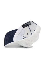 The image shows the inside of the Ole Miss Gameday Hat by No Rivals, featuring a white and navy design, "NO RIVALS" text on the inner band, ventilation holes, and a snapback closure for an adjustable fit.