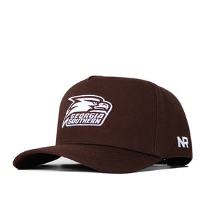 The Georgia Southern Americano Hat is a brown snapback made of high-quality cotton, featuring the Georgia Southern Eagles logo and text on the front plus white NR lettering on the side.
