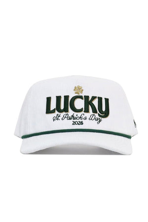 The No Rivals St.Pattys Lucky Cord Hat - White features "LUCKY" in green, a gold shamrock, “St. Patrick’s Day 2026” embroidered below, an unstructured fit, snapback closure, and green brim trim.