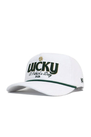 The No Rivals St.Pattys Lucky Cord Hat in white features green and gold "LUCKY" with a shamrock, "St. Patrick’s Day 2026" embroidery, a green-accented brim, unstructured fit, and a small '47 logo on the side.