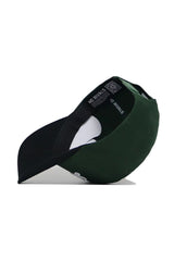 The St.Pattys Shamrock Hat by No Rivals is a green corduroy, unstructured fit cap. Turned upside down, it reveals a black interior with “NO RIVALS” in white and a QR code on the inner band. The brim’s underside is dark.