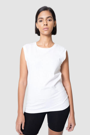 Woman wearing a white sleeveless top and black shorts on a light gray background