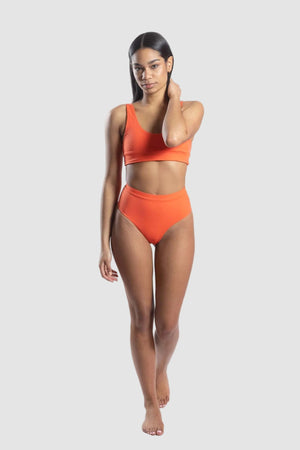 Woman wearing an orange bikini set on a white background