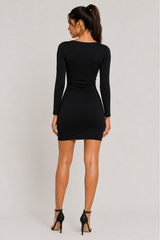Woman wearing a black dress on a plain background