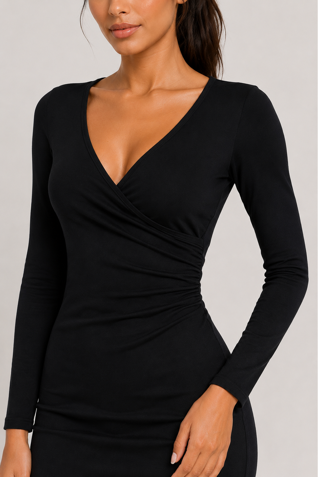 Black long-sleeve dress worn by a model on a plain background